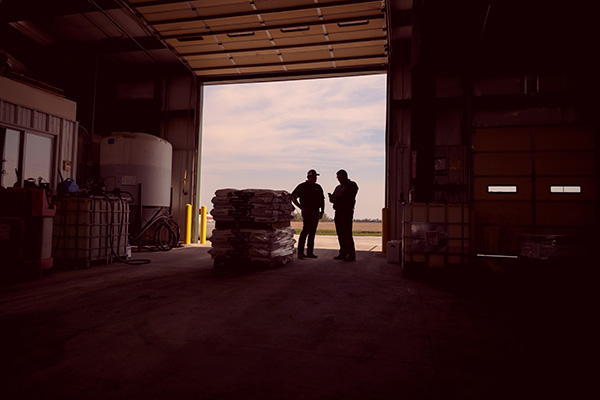 Seed warehouse - open door and men in conversation